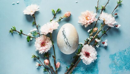 easter egg with marble stone effect and spring flowers on pastel blue background top view flat lay - Powered by Adobe