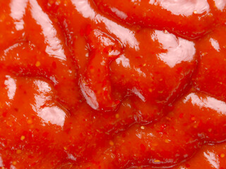 ketchup sauce in a white plate. top view.