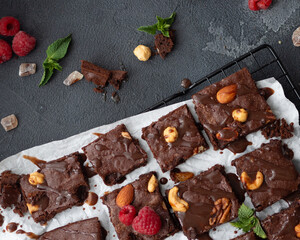 Chocolate brownie with chocolate sauce, top view, dark background