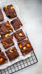 Chocolate brownie with nuts, top view, light background, 