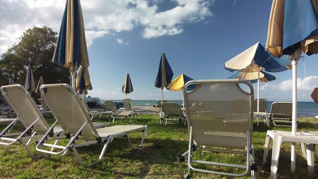 sunbeds and parasols on the beach of Argassi in Zakynthos