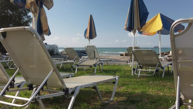 sunbeds and parasols on the beach of Argassi in Zakynthos