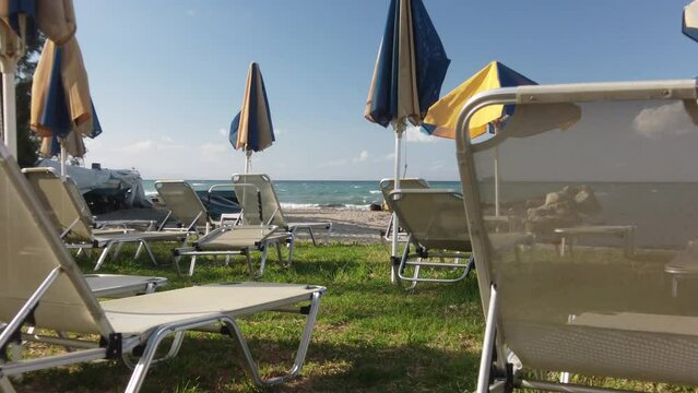 sunbeds and parasols on the beach of Argassi in Zakynthos