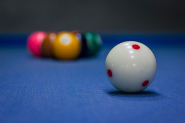 Close up of white billiards ball on a blue table