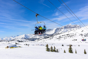 Skiers on the chairlift at Sunshine Village Ski Resort in Banff National Park.