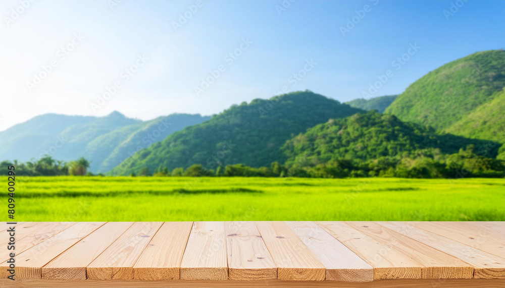 Poster wooden table top on blur mountain and grass field. fresh and relax concept. for montage product disp