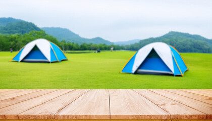 Wooden table top on blur tent camping travel tent and grass field. Fresh and Relax concept. For montage product display or design key visual layout. View of copy space.