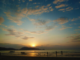 Fantastic view of the dark overcast sky.  Amazing sunset on Patong beach, Phuket. Dramatic and...