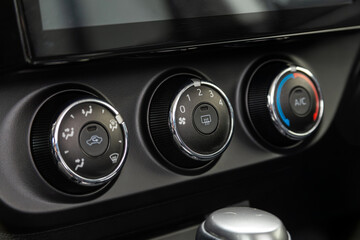  black car interior: climat control view with air conditioning button inside a car