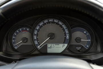 Black car speedometer. Close up shot of the dashboard a car.