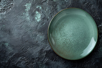 a green plate on a black surface