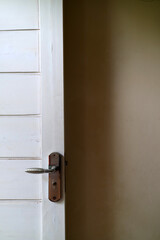 a white wooden door with white walls. with door handles made of aluminum