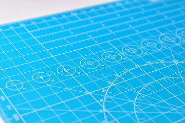 blue cutting mat board background with line and scale measure guide pattern for object art design, tool equipment of diy craft work