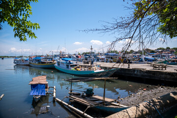 Traditional wooden boats anchor at Paotere Traditional Harbor in Makassar, Indonesia. Paotere...