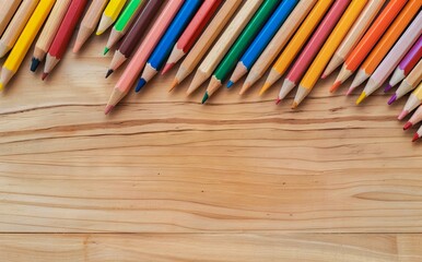 Colorful pencils on wooden table.