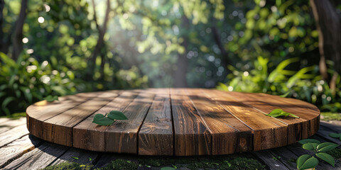 A wooden round table in the forest with green leaves on an out-of-focus backdrop.