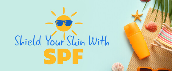Sunscreen cream and beach accessories on light blue background. Banner for Ultraviolet Safety Month