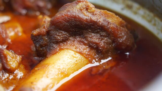 traditional Indian curry lamb masala in a bowl on table 