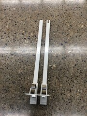 Parts of a Plastic Shelf Pusher System for Retail Merchandising 
