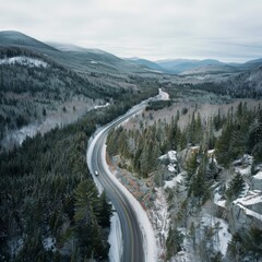 Aerial View of a Mountain Road Cutting Through a Forest