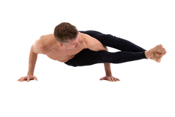 A young attractive man warms up before bray dance. White background.