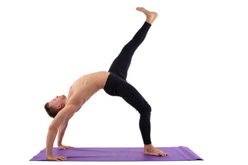 Sports and healthy lifestyle. An attractive man is doing Pilates. White background.