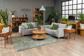 Interior of living room with plants, sofas and tables