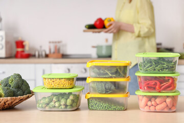 Plastic containers for freezing with vegetables and woman on background