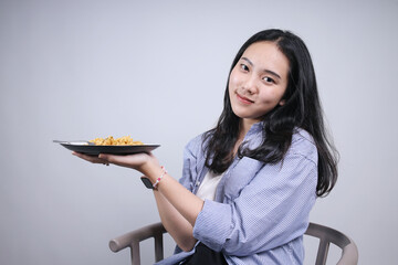 Potrait Of Smiling Young Woman Holding A Plate of Noodles Plate Isolated on White Background 