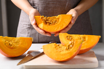 Orange Hokkaido pumpkin with hand prepare for cooking