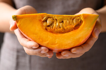 Orange Hokkaido pumpkin holding by hand prepare for cooking