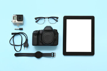 Composition with modern gadgets and glasses on color background