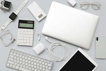 Set of different modern gadgets on grey background