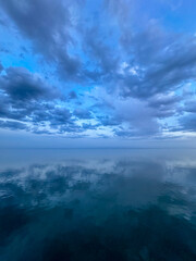 Obraz premium Dramatic clouds over the sea. Natural landscape. rain and large dark clouds over the sea