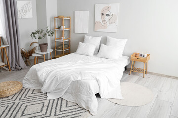 Interior of stylish bedroom with paintings on wall