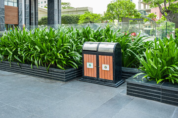 Trash bin containers for sorting recyclable and non-recyclable waste on a urban street of a city in Vietnam