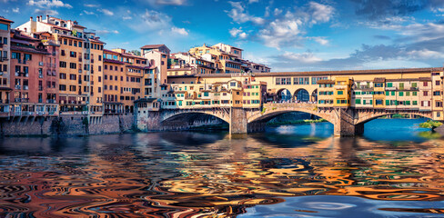 Picturesque summer view of medieval arched river bridge with Roman origins - Ponte Vecchio over...