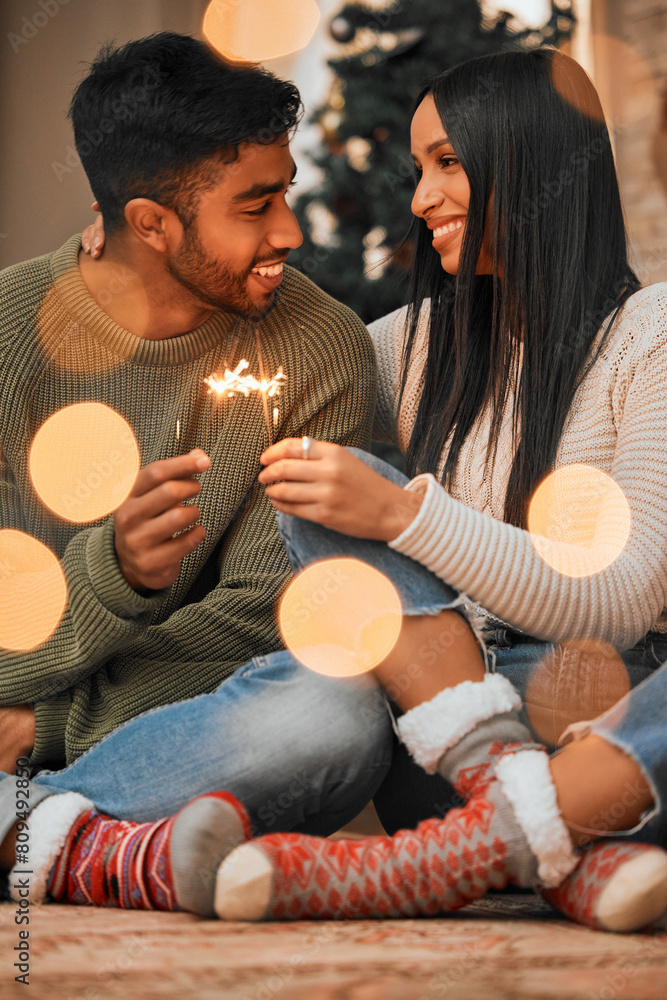 Canvas Prints Couple, people and happy in home with sparklers for Christmas, festive and holiday celebration. Relationship, love and smile for bonding with firework in winter for joy, fun and tradition as soulmate