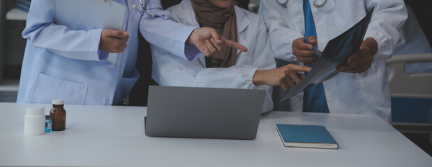 Doctor discussing diagnosis during the meeting. Group of doctor discussing work matter in the office at work. The medical team discusses treatment options with the patient.