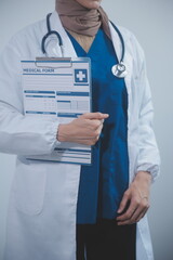 Doctor holding clipboard and stethoscope on background of Hospital ward