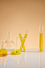 Creative photo for advertising with a measuring cylinder, test tube and erlenmeyer flask of yellow...
