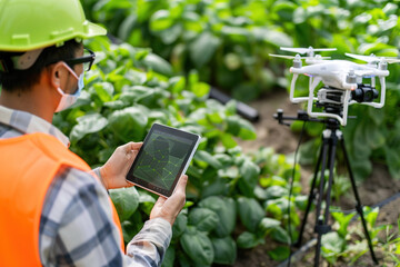 Agricultural worker analyze soil moisture levels using advanced sensors for precision farming.
