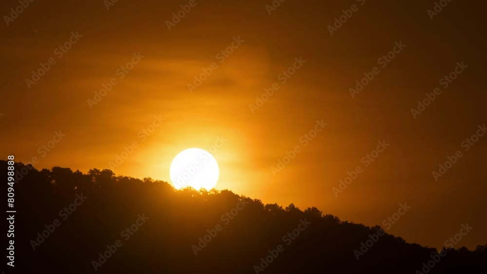 Wall mural timelapse of dramatic sunrise with orange sky in a sunny day.