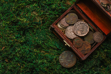 Treasure chest with old coins on the pirate table concept background.