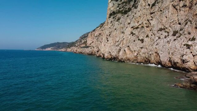 Rocky garraf coast under the bright sun, showcasing the serene mediterranean waters, aerial view