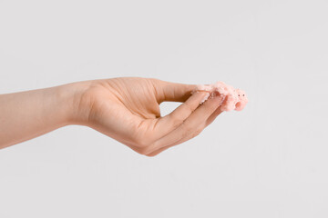 Female hand with natural body scrub on white background, closeup