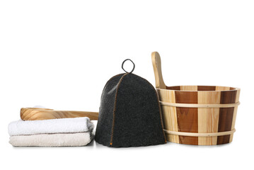 Wooden bucket, felt hat, ladle and towels for sauna on white background