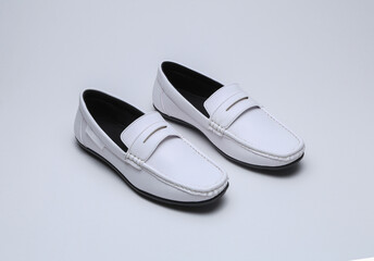 white leather loafers slip on shoes isolated on grey background