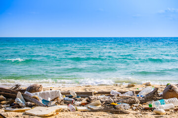 trash, plastic cups and plastic bags at the beach. environmental problem concept and healing the...