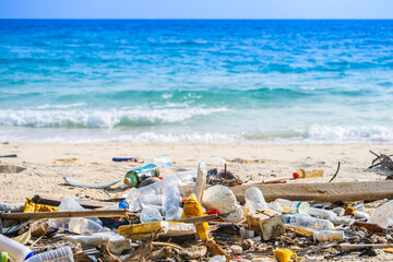 trash, plastic cups and plastic bags at the beach. environmental problem concept and healing the...